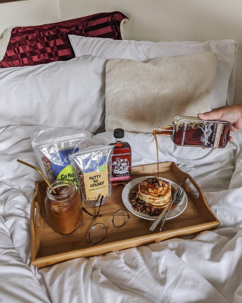 Breakfast tray with pancakes, maple syrup, granola snack packs and Nutty No Grainer