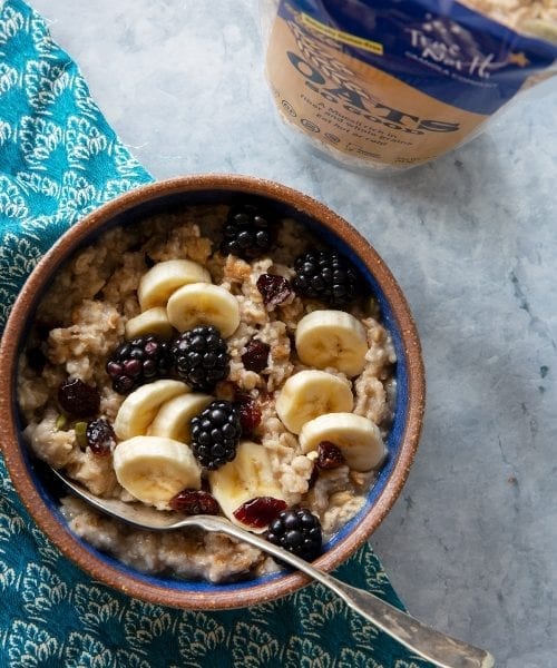 Bowl of GF Oats So Good Muesli topped with fruit and berries